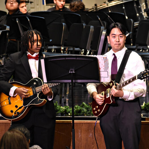 Jazz Band's guitar section, including junior Kai Weems and senior Christian Abadilla, takes center stage, opening the concert. (Photo by Karidja Monjolo)