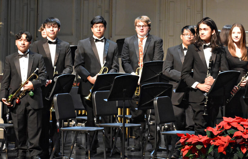 The woodwind section receives a round of applause from the audience.